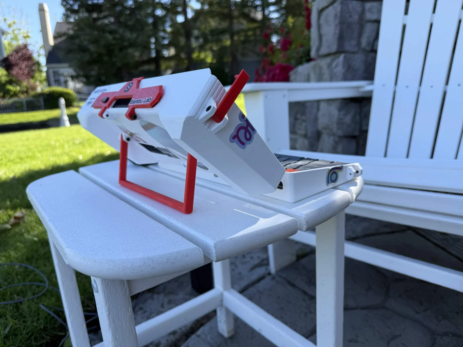 The white and red cyberdeck’s folding stand in an outdoor setup.